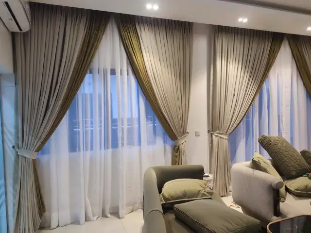 Beige and olive two-tone curtains in a living room